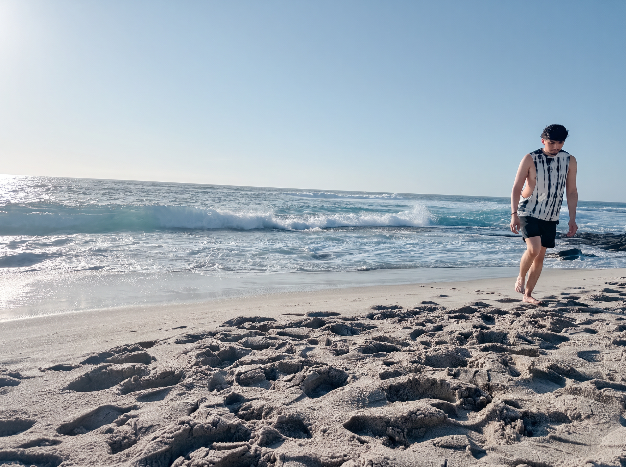 Man walking along the shoreline